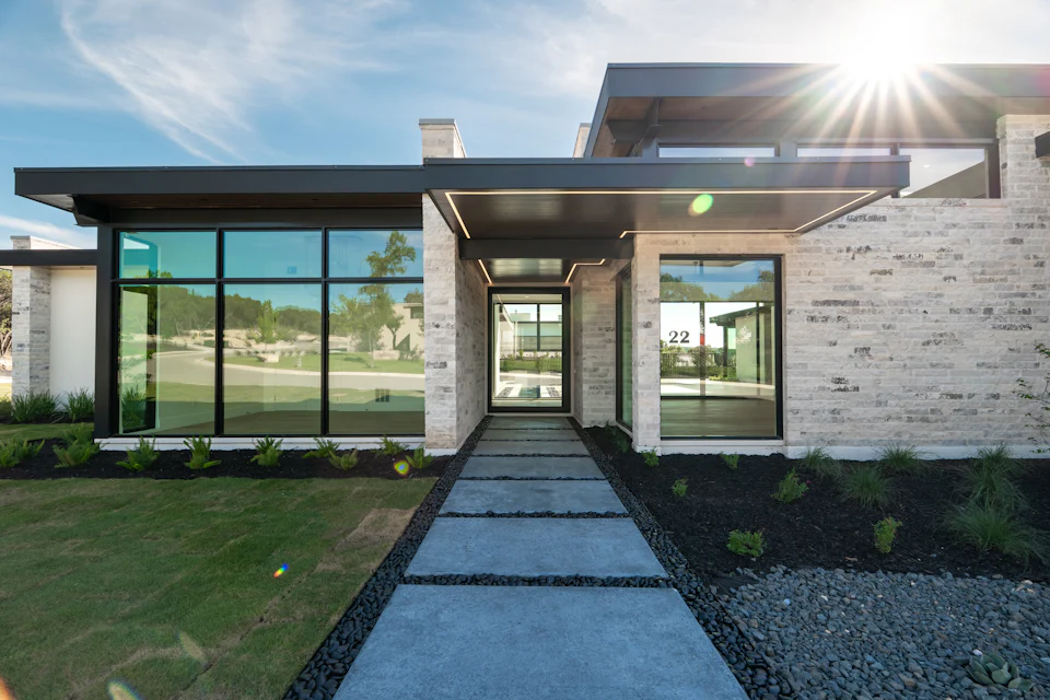 A contemporary home with a stone facade and large windows