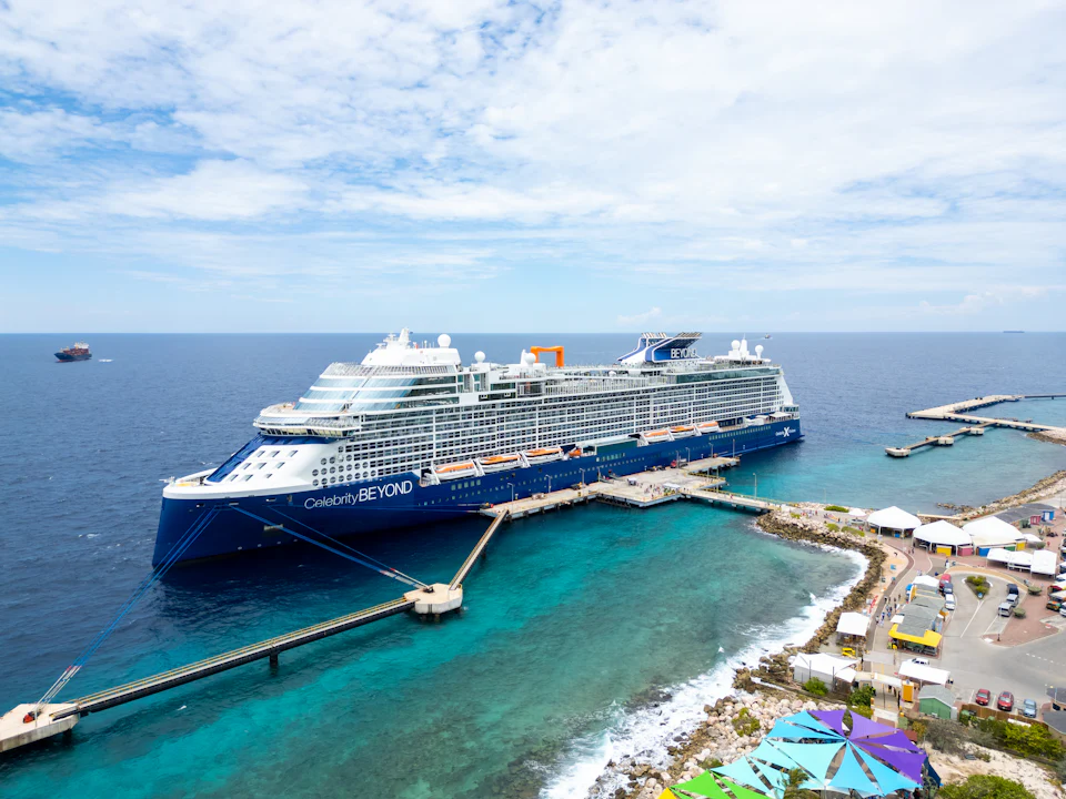 A cruise ship docked at a pier, seen from above